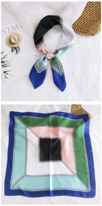 Detail of silk square scarf featuring geometric color blocks and gold chain patterns
