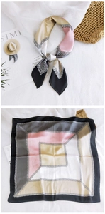 Close-up of square silk scarf with color-block patterns and elegant chain prints