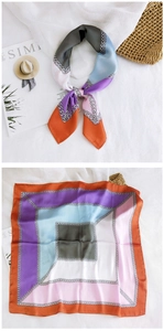 Detailed close-up of a satin square scarf with chain pattern and silk luster texture
