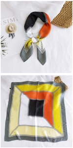 Detail of geometric chain print square scarf with orange and black silk texture blocks