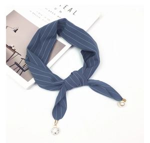 Detail of blue striped silk scarf with elegant pearl and rhinestone sphere pendants