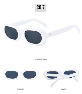 Detail view of white polygon sunglasses with metallic rivets and dark gray lenses