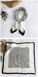 Detail of minimalist black and white geometric silk scarf with central OVEL lettering
