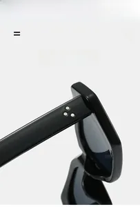 Detail shot of black polygon sunglasses with stylish silver triple-stud rivet accents