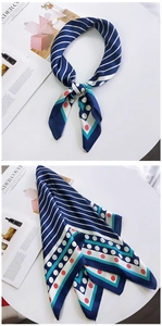 Détail de foulard en soie avec motifs géométriques bleus, rayures blanches et pois rouges