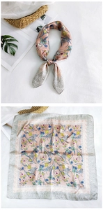 Detailed view of floral silk neck scarf in lotus pink with elegant botanical patterns