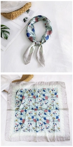 Detail of mint green floral silk scarf with vintage grey border and botanical patterns
