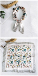 Detailed pattern of floral print silk scarf with vintage lace edges and smooth texture