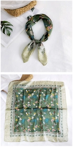 Detail of green floral silk scarf with satin finish and small flower pattern design