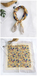 Detail of square ginger silk scarf with blue tulip and purple daisy floral prints