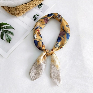 Elegant floral silk scarf in retro mustard yellow with lace details on a white background