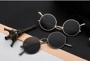 Two pairs of retro round metal frame sunglasses in vintage gold and silver finishes