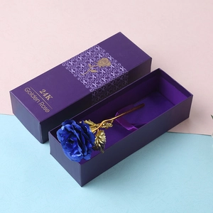 Detailed view of artificial blue 24K gold foil rose inside a purple luxury gift box