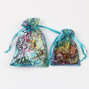 Macro view of blue organza gift bags with metallic coral texture and ribbon closure