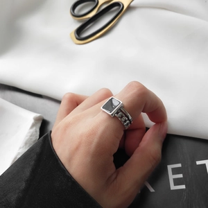 Detail of S925 sterling silver chain ring with black square resin inlay on hand