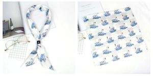 Vue détaillée du foulard en soie cygne abstrait avec boucle en cuir et motif artistique chic