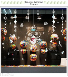 Detail of Christmas window stickers featuring snowman, reindeer and holiday greetings