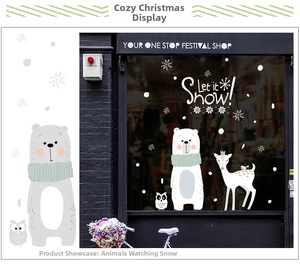 Detail view of polar bear and deer Christmas window stickers on shop glass