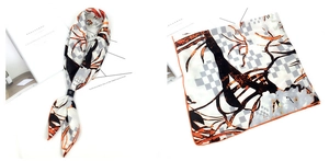 Détail d'un foulard en soie style peinture à l'huile avec motif en damier orange et noir