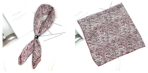 Détail d'un foulard en satin abstrait rouge avec bords roulés et boucle en cuir