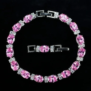 Macro detail of oval pink zircon bracelet with small white diamonds on silver chain
