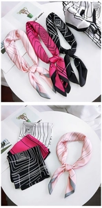 Detail of silk-like square scarf featuring geometric line patterns and contrast edging