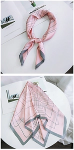 Detail of pink silk square scarf with grey geometric lines and contrast rolled edges