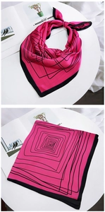 Close-up of pink silk square scarf with geometric black lines and black borders