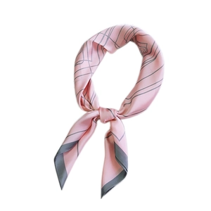 Pink silk square scarf with grey geometric lines shown in a stylish knotted display