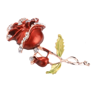 Elegant rose brooch with red enamel petals and white rhinestones on rose gold finish