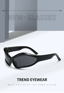 Close-up of futuristic Y2K sports sunglasses featuring broad black temples and dark lenses