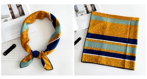Detail of linen-feel striped scarf with white polka dots in ginger and blue colors