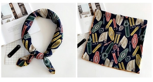 Detail of silk square scarf showing nautical belt prints and gold hemmed edges