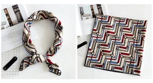 Close-up of linen-feel square scarf featuring red and blue geometric chain patterns