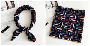 Detail of navy blue linen scarf featuring vintage geometric patterns and yellow hem stitching