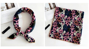 Detail of floral linen silk square scarf showing print patterns and orange hemmed edges