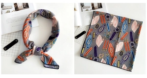 Detail of grey square silk scarf with vintage belt print and elegant glossy texture