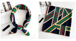 Detail of colorful striped square silk scarf showing hand-rolled edges and geometric pattern