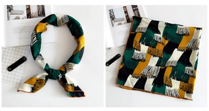 Detail of color-block printed linen scarf with fine orange rolled hem and geometric pattern