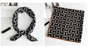 Detail of linen-feel silk scarf with horseshoe geometric patterns and orange border