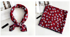 Detail of burgundy floral square scarf with elegant white patterns in a French chic style