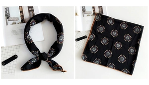 Detail of black floral square scarf featuring colorful mandala patterns and edge stitching