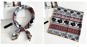 Close-up of exotic elephant print linen scarf with retro geometric border and yellow edge