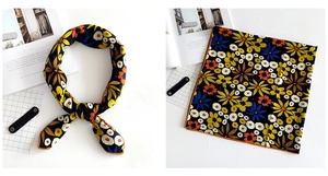 Detail view of square linen-feel silk scarf with vintage floral print and vivid colors
