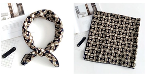 Detail of elegant square scarf with classic horsebit chain pattern and navy border