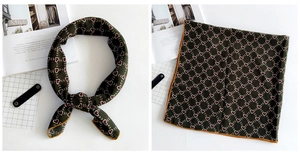 Detail of dark green silk scarf with red hearts, yellow borders, and a diagonal arrow grid