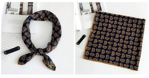 Detailed view of navy blue paisley linen scarf with yellow rolled edges and soft texture