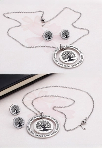 Macro shot of stainless steel Tree of Life necklace set with engraved inspirational words