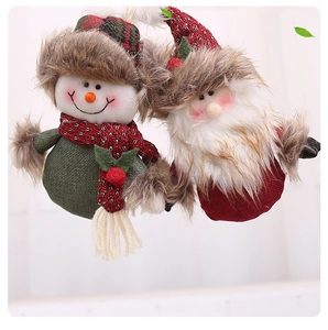 Close-up of handmade Christmas plush ornaments featuring Santa and Snowman with knit textures