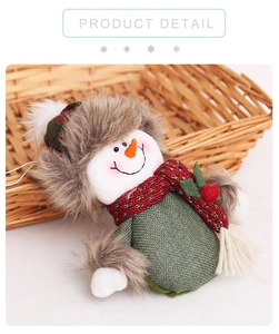 Detail of Christmas snowman plush ornament featuring a green linen body and fur hat